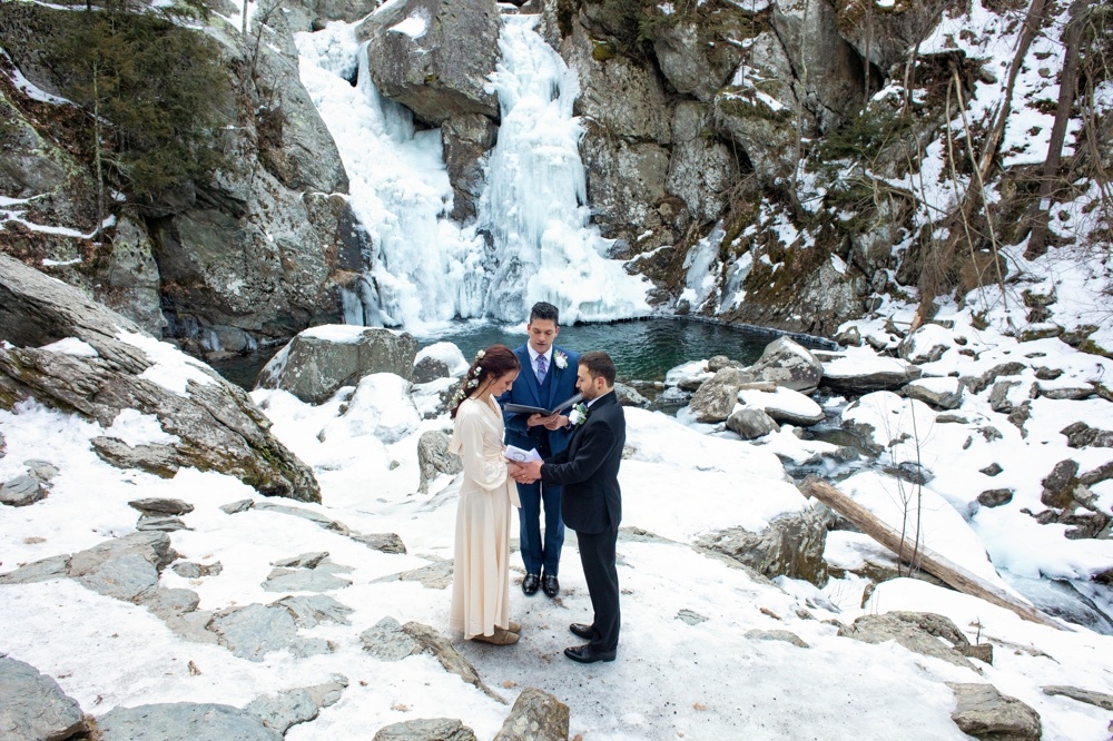 Frozen Bash Bish Falls behind elopement couple